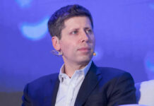 Man in suit with headset microphone on stage