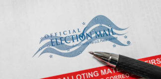 Mail-in ballot envelope with pen