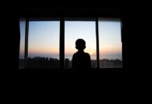 Chilling Dutch Move — Under‑12 Euthanized Silhouette of a child looking out a window at a sunset