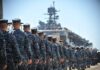 Why Was a Missing Sailor Treated as AWOL? Navy personnel marching in formation towards a ship