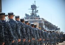 Why Was a Missing Sailor Treated as AWOL? Navy personnel marching in formation towards a ship