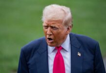 Trump Pick Triggers Intelligence Knife Fight A political figure speaking outdoors with an expressive gesture