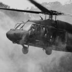 Military helicopter hovering with soldiers at open door