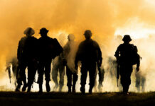 Debt Brake Axed—War Machine Rises Silhouettes of soldiers walking through smoke at sunset