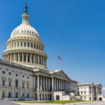 United States Capitol building with dome under clear blue sky