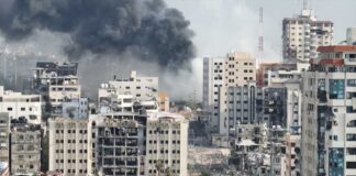 City buildings with heavy smoke and extensive war damage