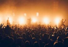One Concert Joke Sparked A White House Response Rock band performing on stage with bright backlights and cheering crowd