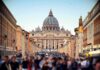 Shock Schism: Excommunications Rock Tradition St. Peter's Basilica viewed from a busy street with crowds
