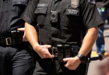 Why ICE’s Camera Rollout Suddenly Matters Police officers in black uniforms with duty belts