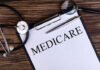 Washington Targets Medicare Fraud With New Freeze A document labeled 'Medicare' with a stethoscope and magnifying glass on a wooden surface