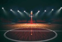 The WNBA’s Next Battle Isn’t Basketball Basketball hoop on an empty indoor court under bright arena lights