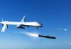The Pentagon’s Silent Answer To Drone Warfare military drone firing missiles in clear blue sky