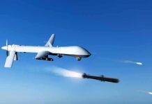 military drone firing missiles in clear blue sky