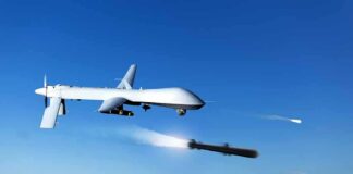 military drone firing missiles in clear blue sky