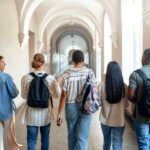Group of students walking through a university corridor