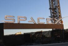 Starlink Network Grows With Latest Launch Sign displaying the SpaceX logo at a launch site