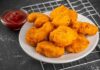 Plate of golden chicken nuggets with a side of ketchup