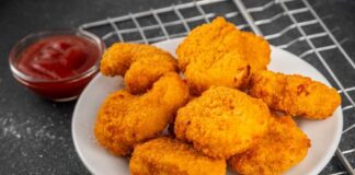 Plate of golden chicken nuggets with a side of ketchup