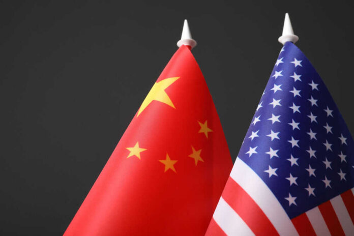 us-china593900280 Chinese and American flags side by side.