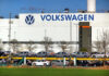 Volkswagen factory exterior with new cars on transport racks