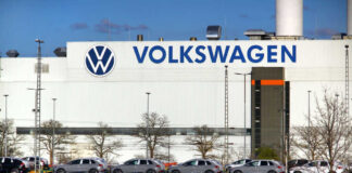 Volkswagen factory exterior with new cars on transport racks