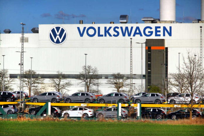 Volkswagen factory exterior with new cars on transport racks