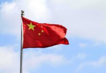 Chinese national flag waving on a flagpole