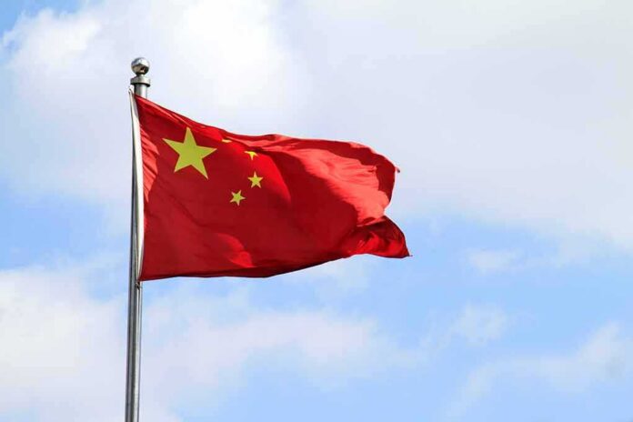shutterstock_1060497302 Chinese national flag waving on a flagpole