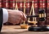 New Testimony Deepens Questions in Murder Trial Judge's hand holding gavel near scales of justice