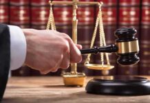 New Testimony Deepens Questions in Murder Trial Judge's hand holding gavel near scales of justice