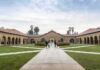 America’s College Shakeout Has a Small-Town Price Courtyard with stone arcades and palm trees at a university campus