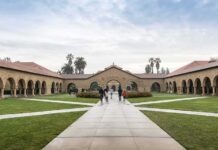 Courtyard with stone arcades and palm trees at a university campus