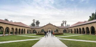 Courtyard with stone arcades and palm trees at a university campus