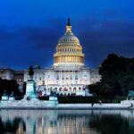 United States Capitol building at dusk with lights glowing