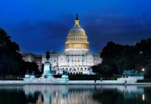 United States Capitol building at dusk with lights glowing