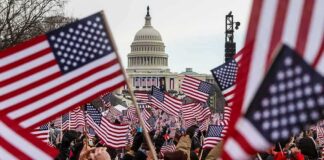 Crowd waving American flags near the U.S. Capitol