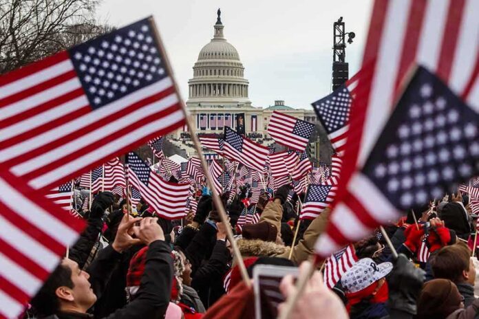 shutterstock_125879927 Crowd waving American flags near the U.S. Capitol