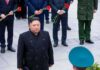 man in black coat at formal ceremony