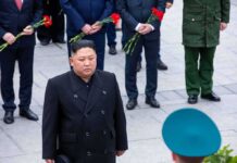 man in black coat at formal ceremony