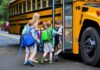 Children boarding a yellow school bus