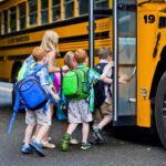 Children boarding a yellow school bus