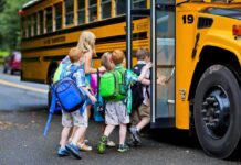 Children boarding a yellow school bus
