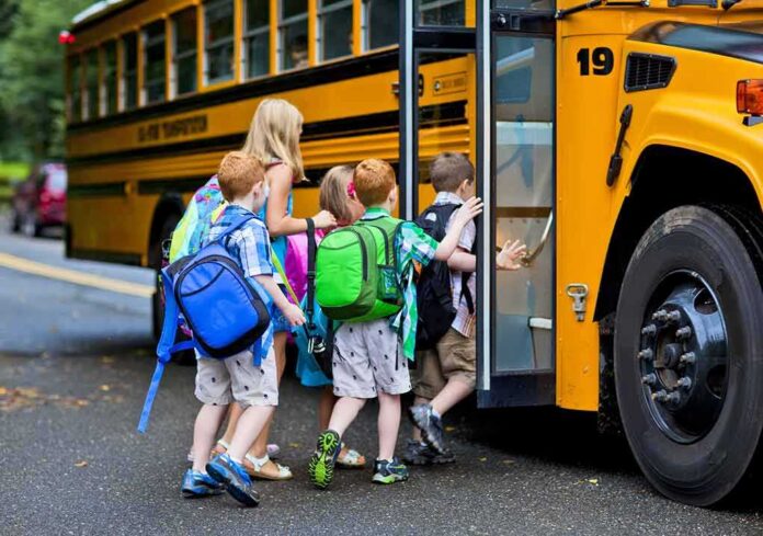 Children boarding a yellow school bus