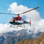 Cliff Crash Sparks Daring Rescue Over Pacific helicopter flying over mountain landscape