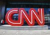 CNN red logo sculpture outside a building entrance