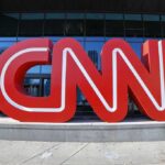 CNN red logo sculpture outside a building entrance