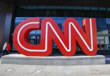 CNN red logo sculpture outside a building entrance