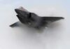 Stealth fighter jet piercing a vapor cloud