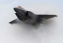 Stealth fighter jet piercing a vapor cloud