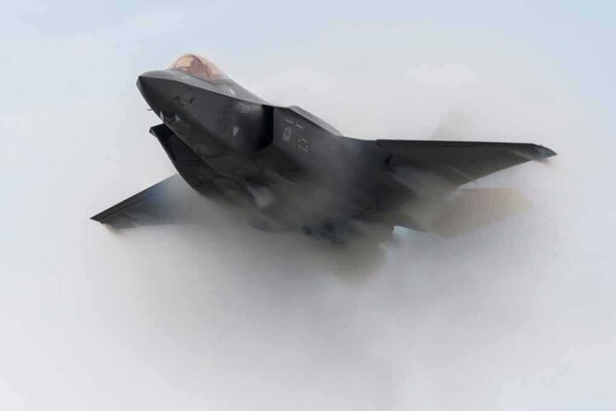 Stealth fighter jet piercing a vapor cloud